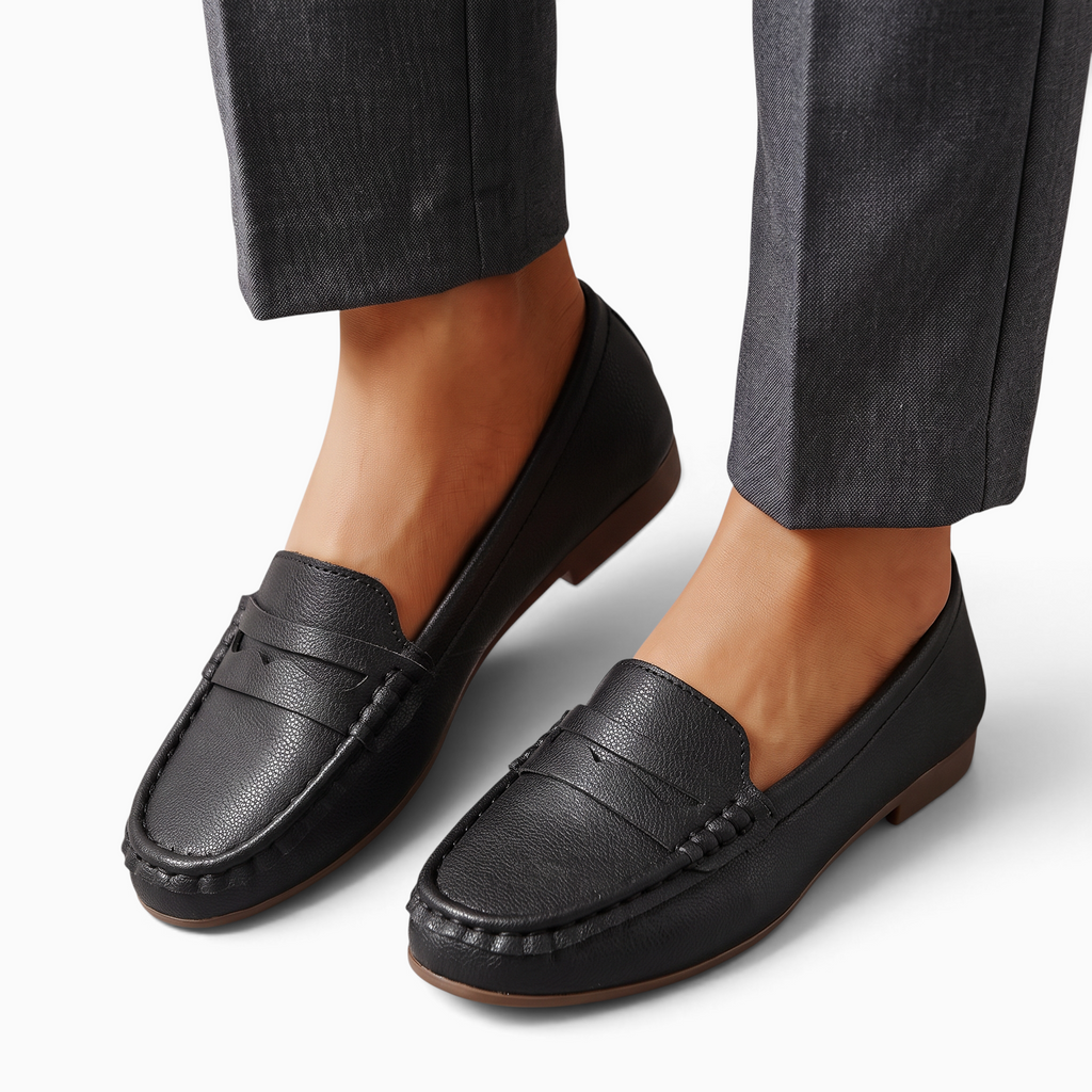 Mocassin Paris femme en cuir synthétique noir à semelle plate, bout rond et style décontracté porté avec un pantalon